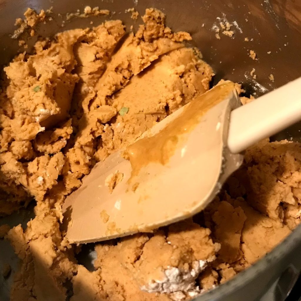 besan, butter, sugar, and cardamom are mixed together until thoroughly combined.