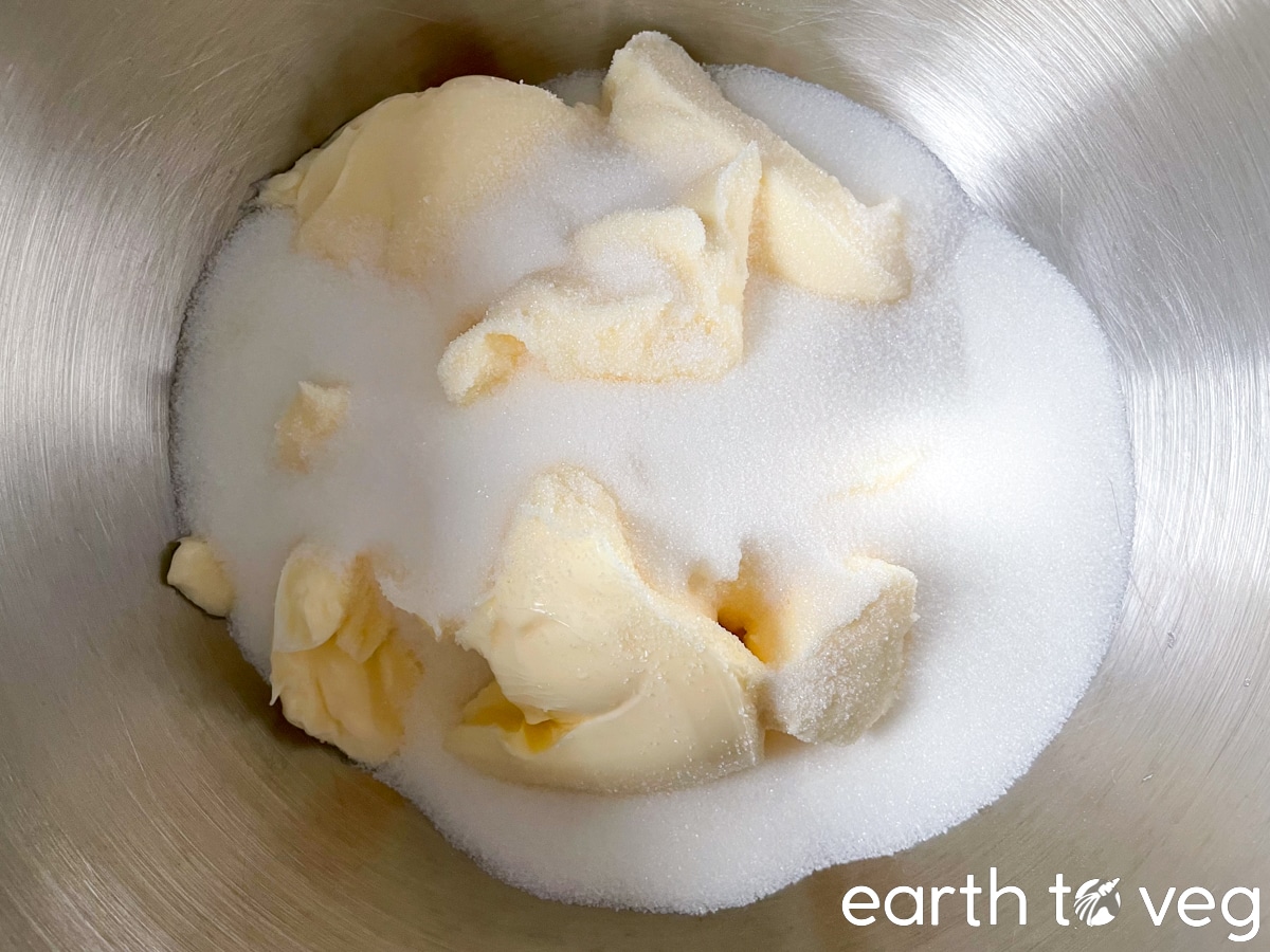 Butter and sugar are added to a stand mixer bowl.