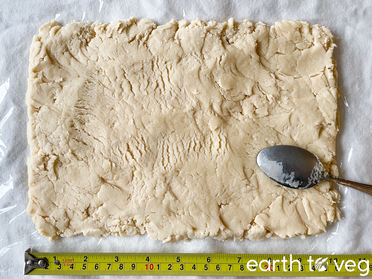 flattened cookie dough rectangle with tape measure