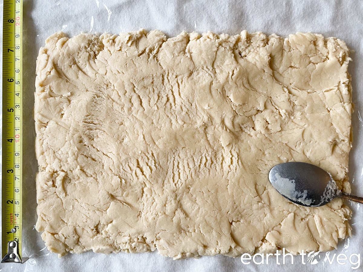 flattened cookie dough rectangle with tape measure