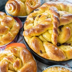 an assortment of vegan paska breads sit on a gingham tablecloth.