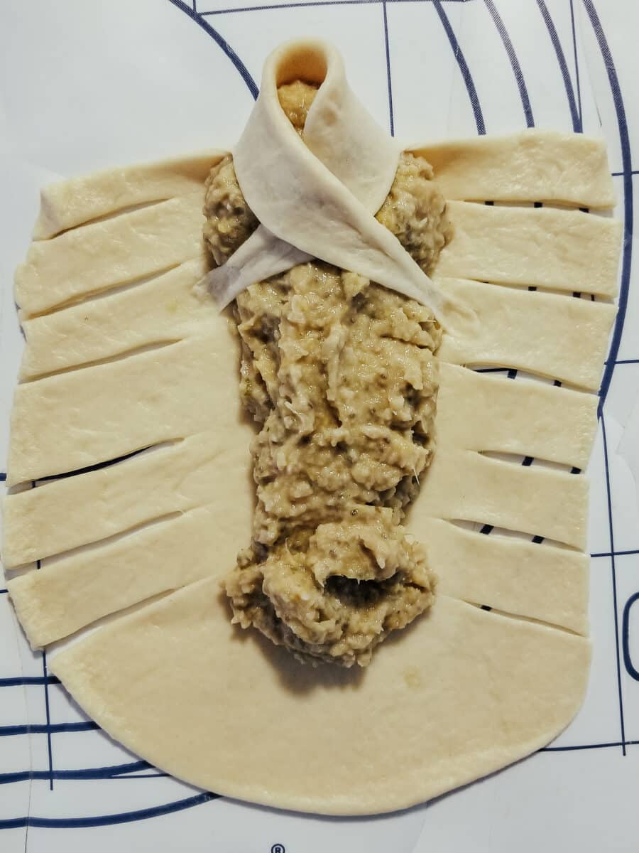 shaping and wrapping crescent roll dough for goldfish in a blanket