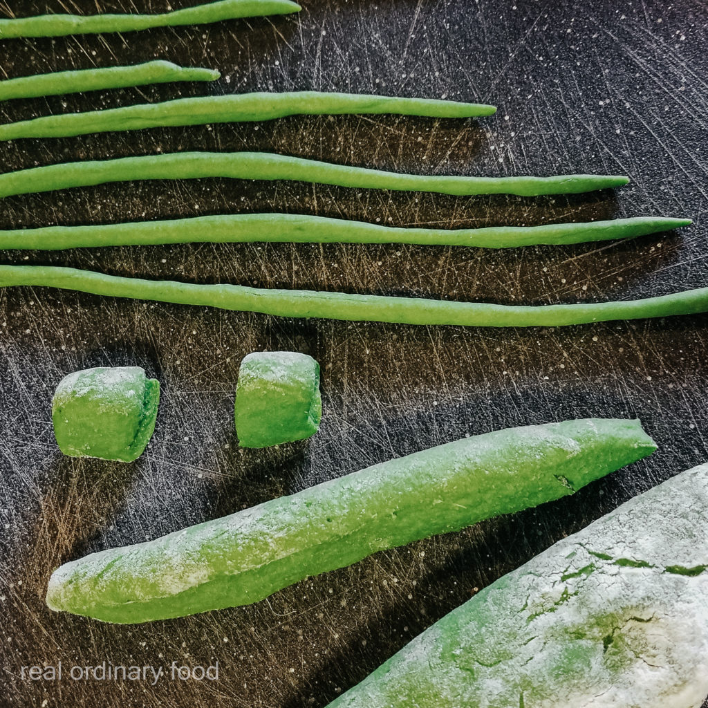 rolling homemade spinach pici pasta