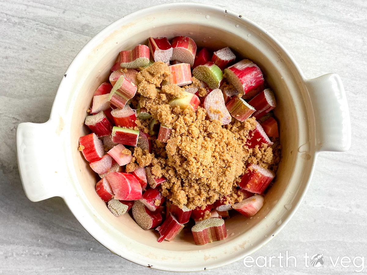 brown sugar on top of chopped rhubarb in a Dutch oven.