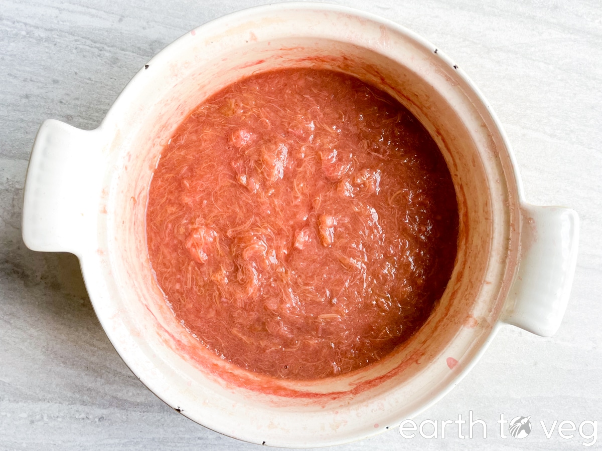 a pot full of cooked rhubarb pulp.