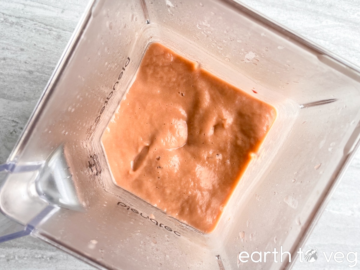 a Blendtec blender jar is full of puréed rhubarb.