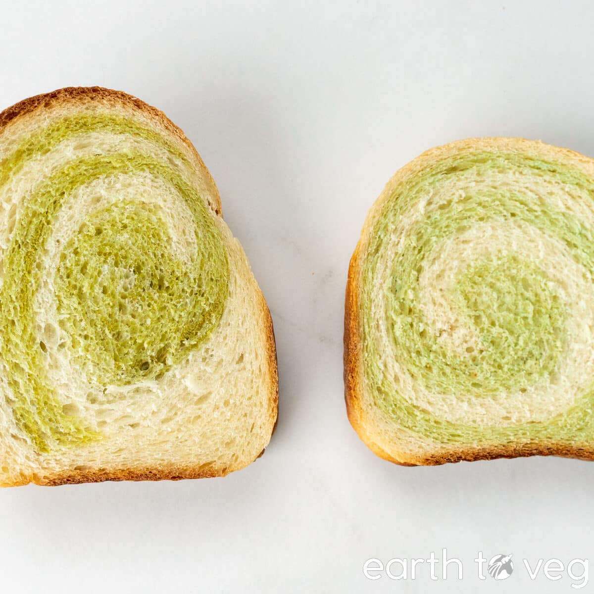 A slice of unstrained pandan bread rests side-by-side next to a slice of strained pandan extract bread.