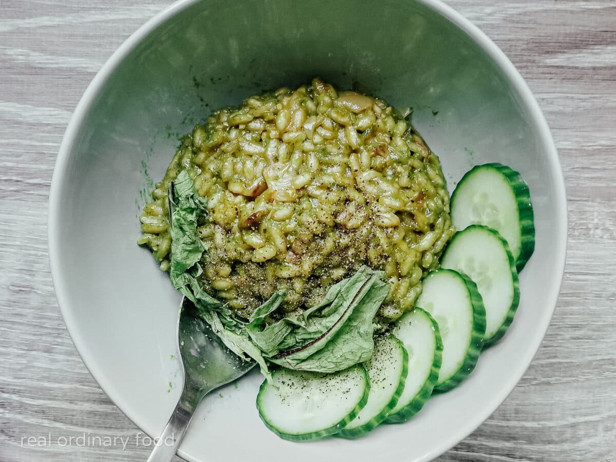 green dandelion pesto risotto with cucumber slices