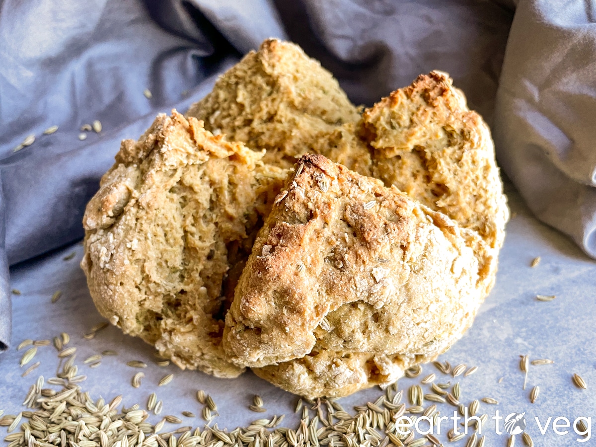 a loaf of irish soda bread on a grey tile backdrop