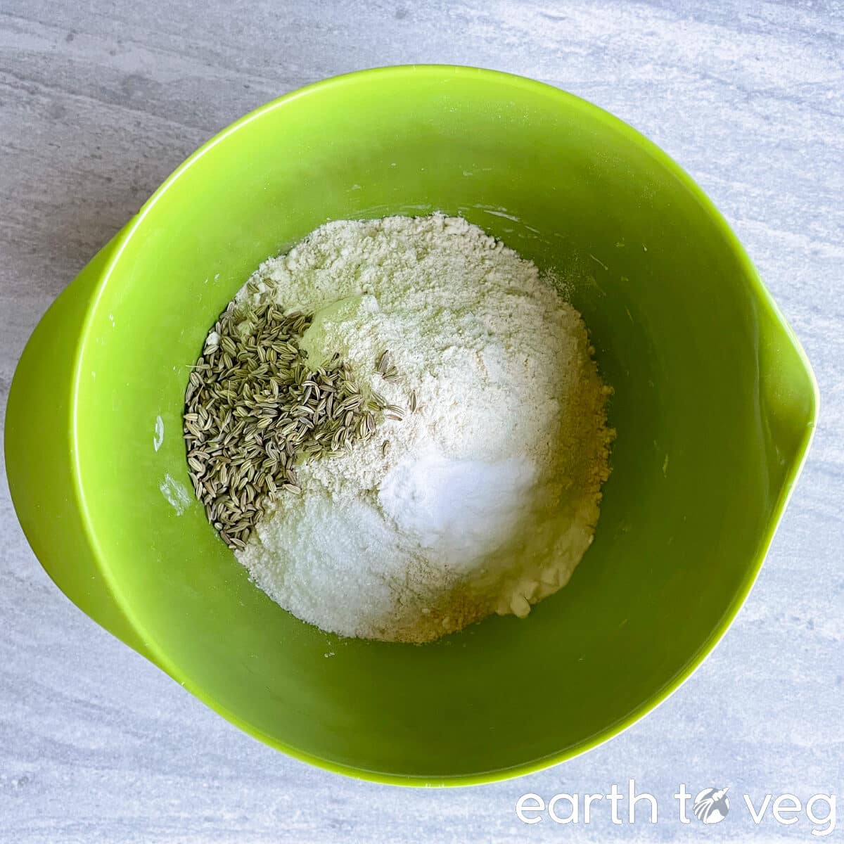 Dry ingredients for irish soda bread, unmixed, in a green bowl.
