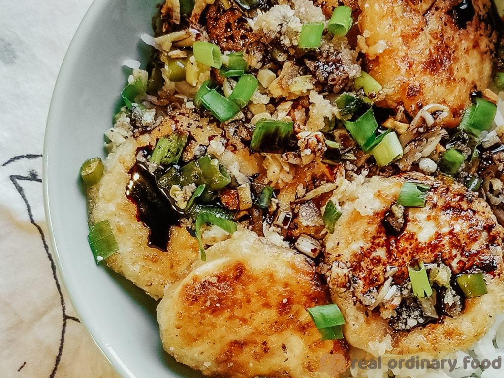 pan-fried crunchy soft tofu with scallions and dark soy sauce over steamed rice