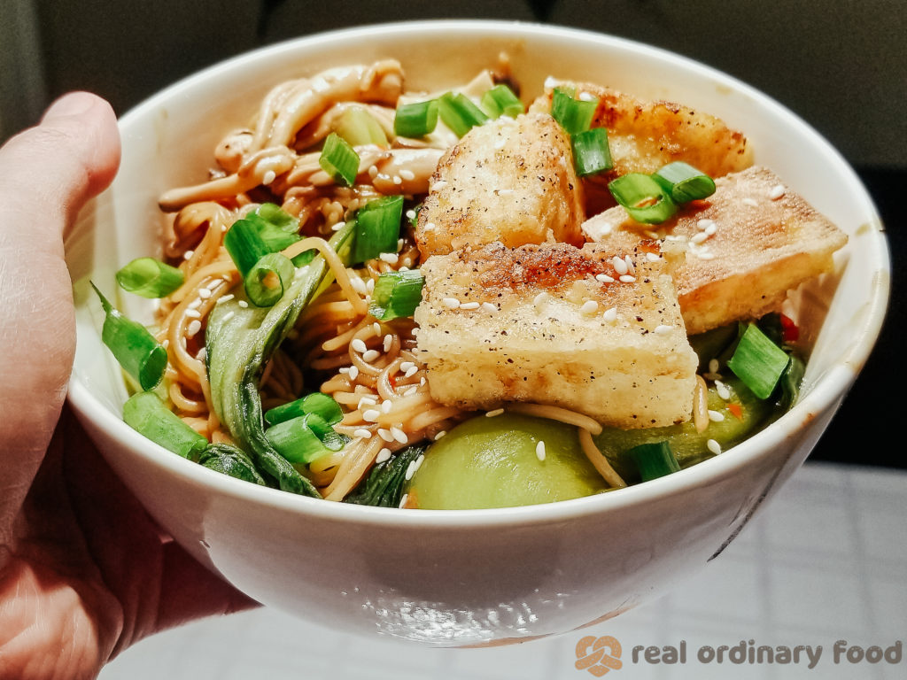 pan-fried soft tofu over brown rice noodles with bok choy and oyster mushrooms