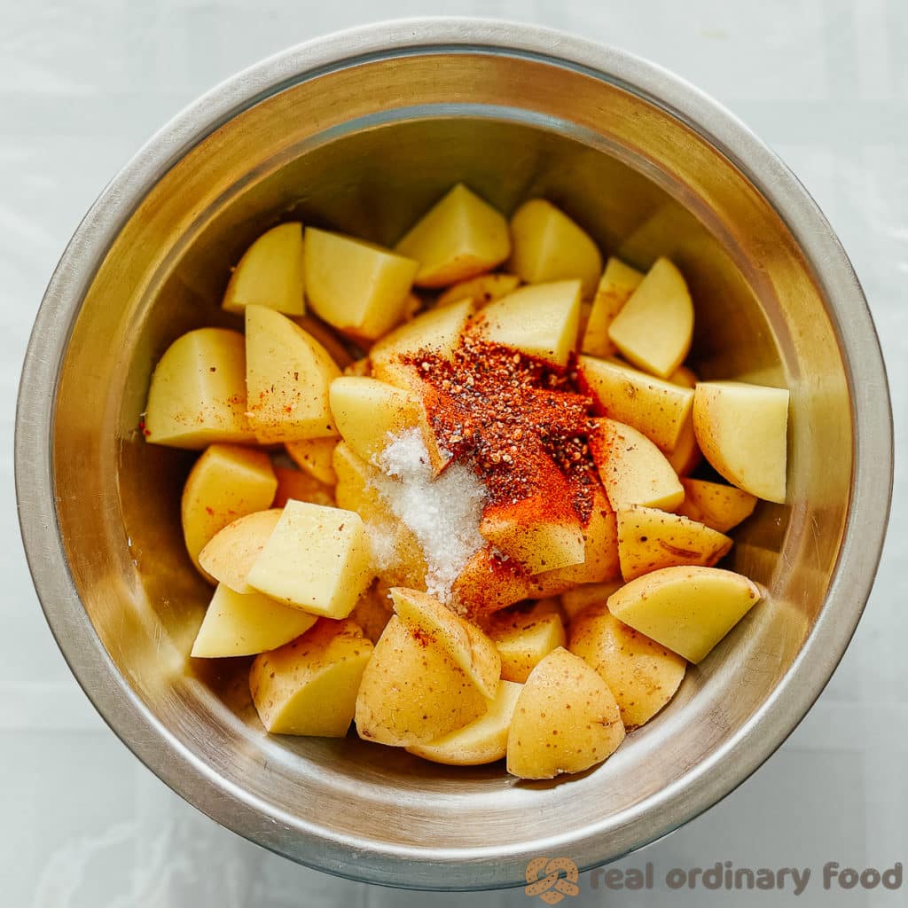 Salt and shichimi togarashi sprinkled over chopped potatoes.