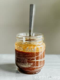 A small glass jar of homemade tahin pekmez on the kitchen table.