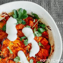 Casserole dish full of borani banjan with yogurt on top.