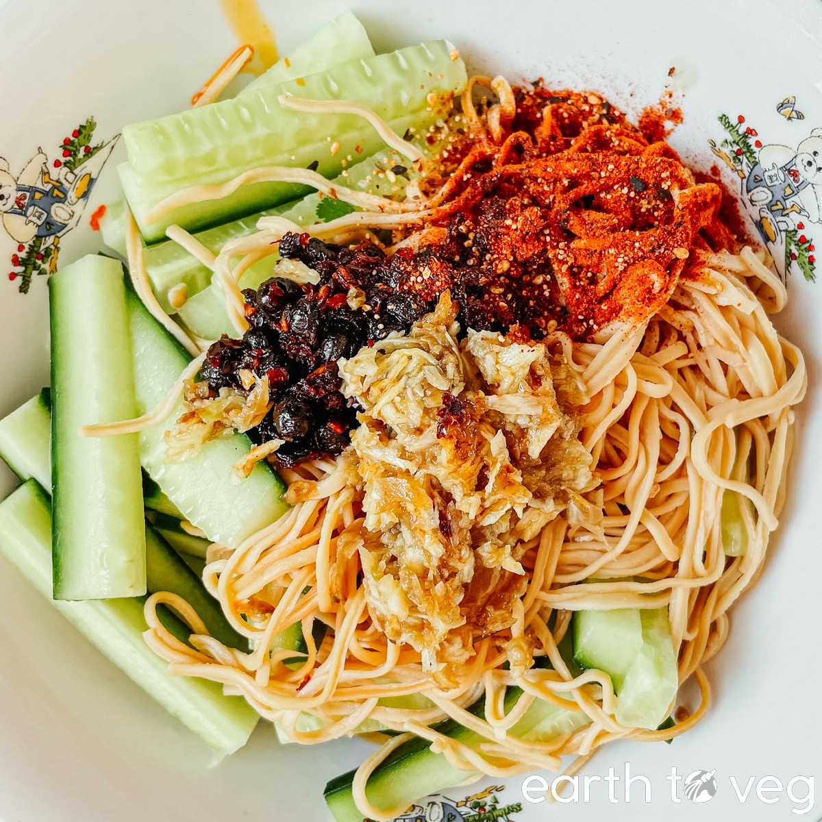 A sprinkle of shichimi togarashi is tossed over the salad bowl.