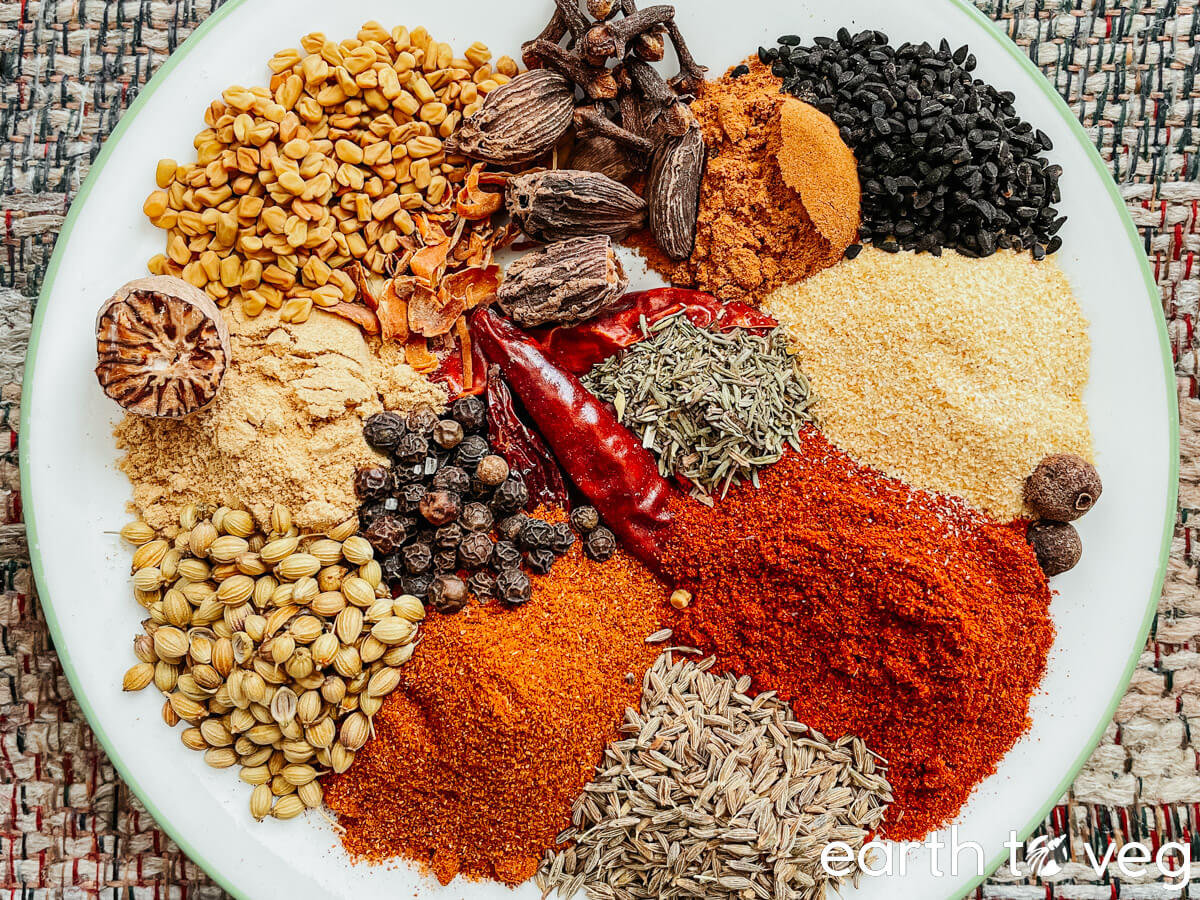Plate full of spices for making berbere blend.