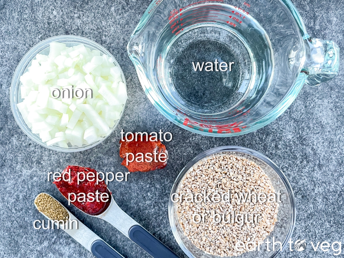 The ingredients for kisir salad base are laid out on a grey countertop.