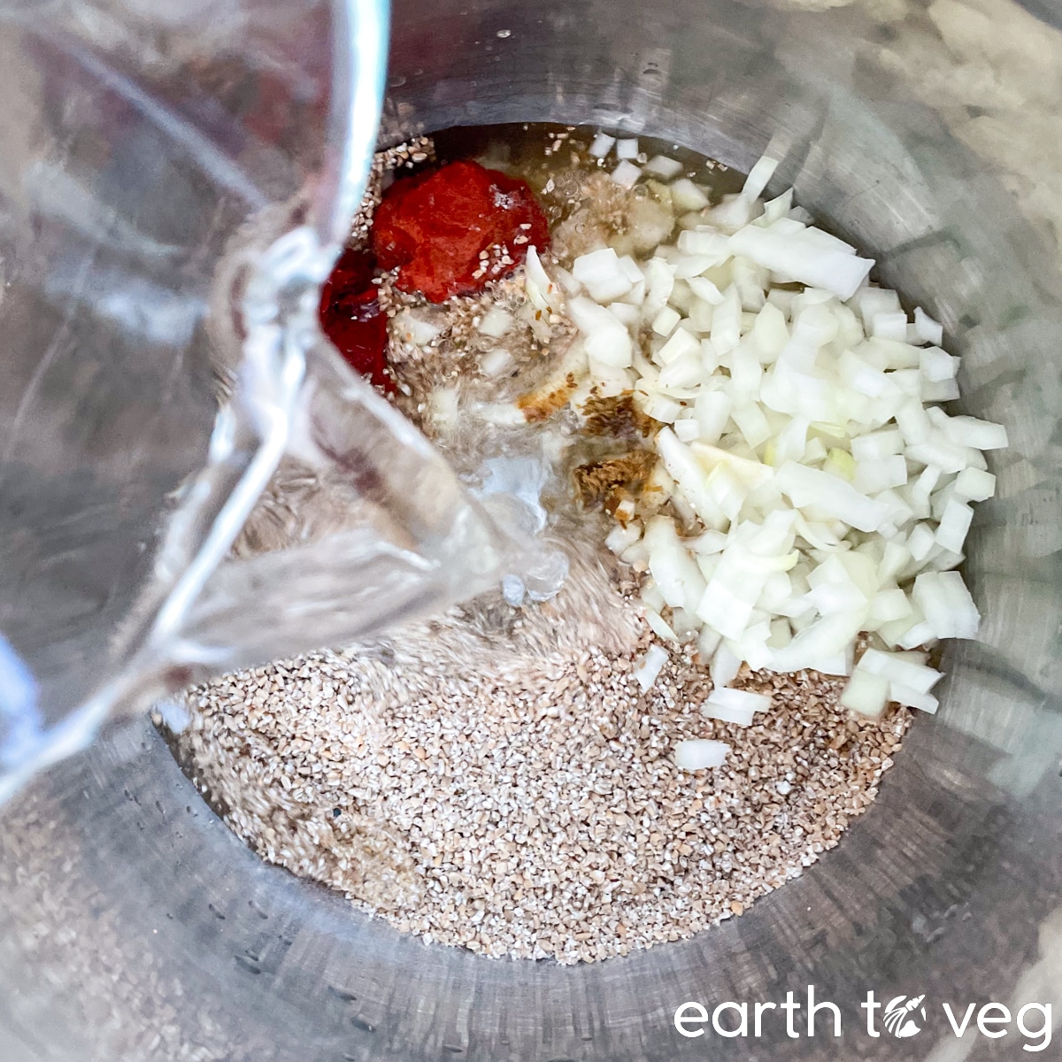 Water being poured into an Instant Pot filled with kisir base ingredients.