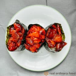 Watermelon gunkan maki sushi on a white plate.