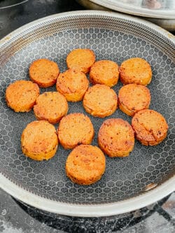 frying sliced vegan Andouille sausages in skillet
