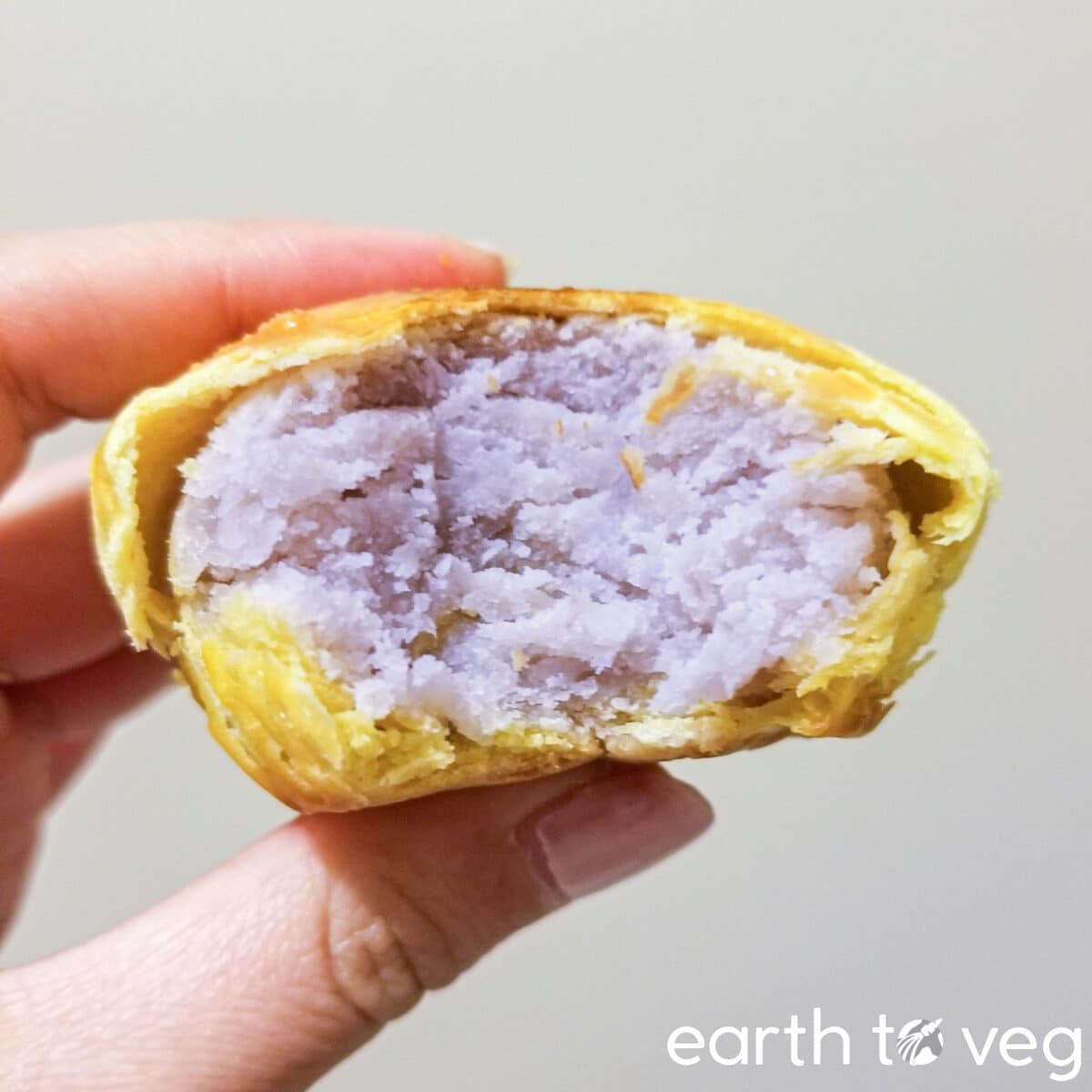 A hand holding up a taro pastry from a Chinese bakery in Toronto.