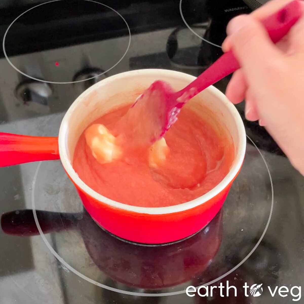 Butter is stirred into pink pie filling.
