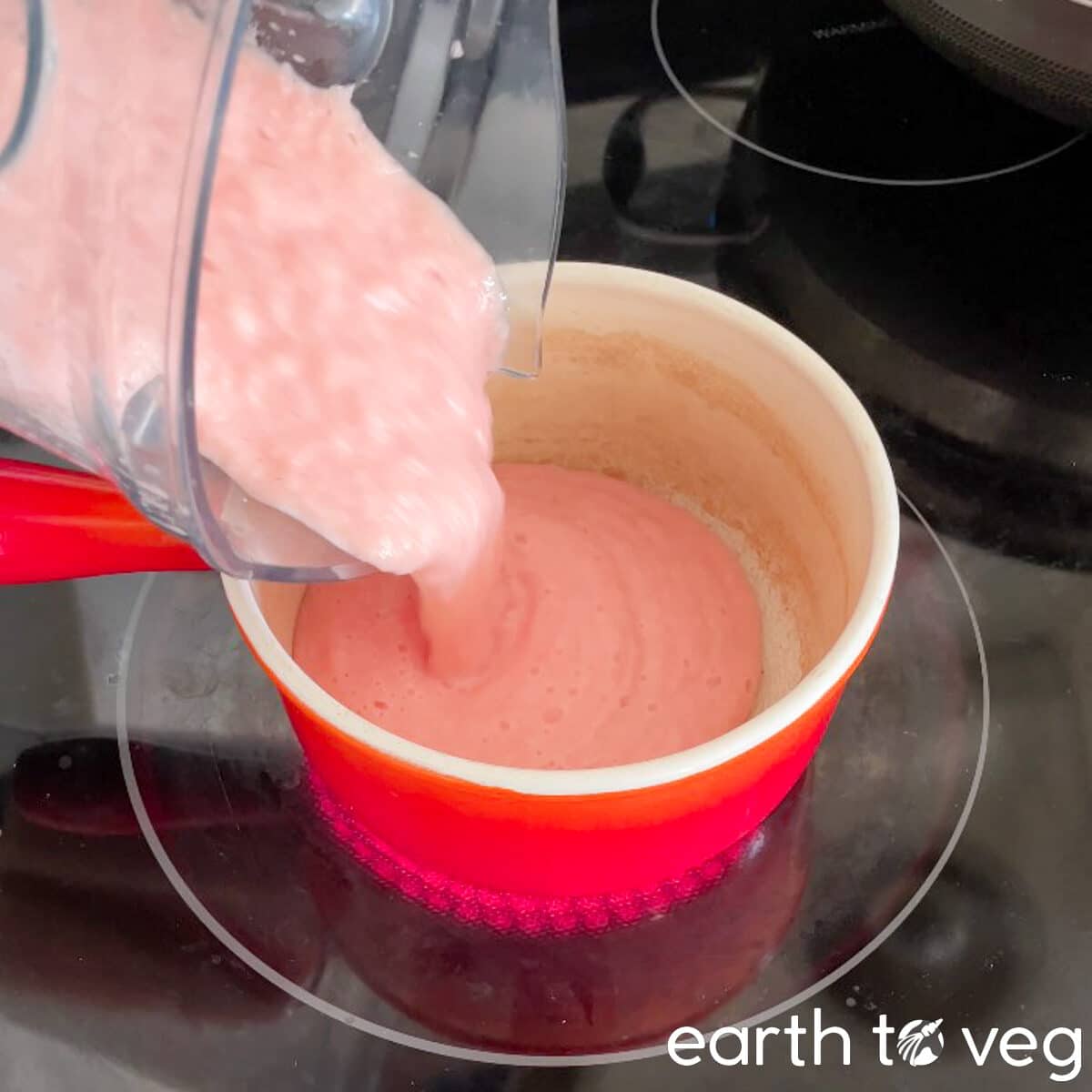 Pink filling mixture is poured into a saucepan.