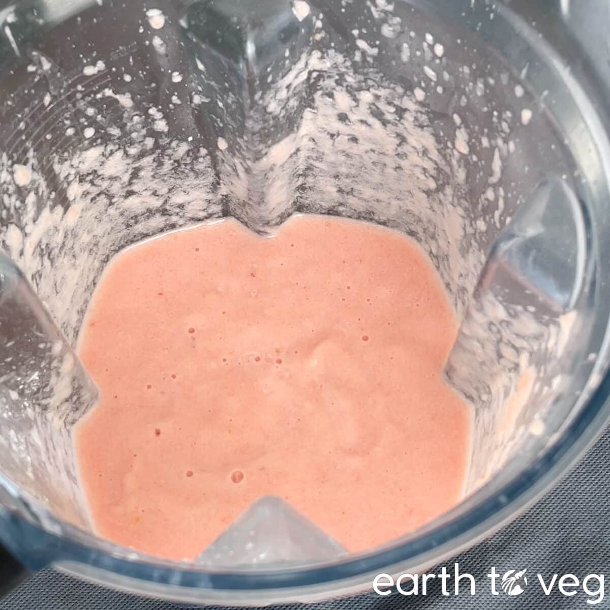 Pureed pink pineapple filling in the blender.