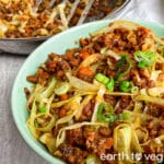 Vegetarian egg roll in a bowl on a grey countertop.