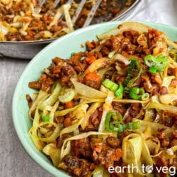 Vegetarian egg roll in a bowl on a grey countertop.