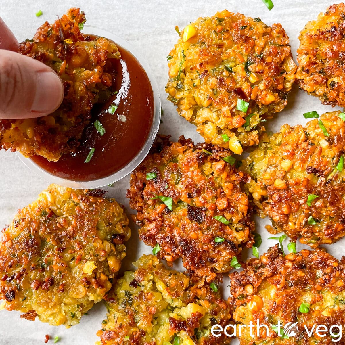 Freshly fried paruppu vadai is dipped in spicy ketchup.