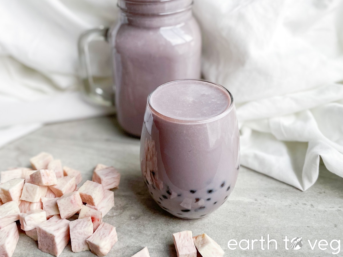 Two glass mugs full of dairy-free taro bubble tea.