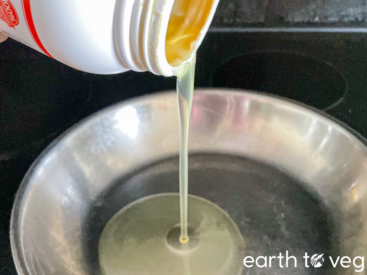 pouring tahini oil onto skillet