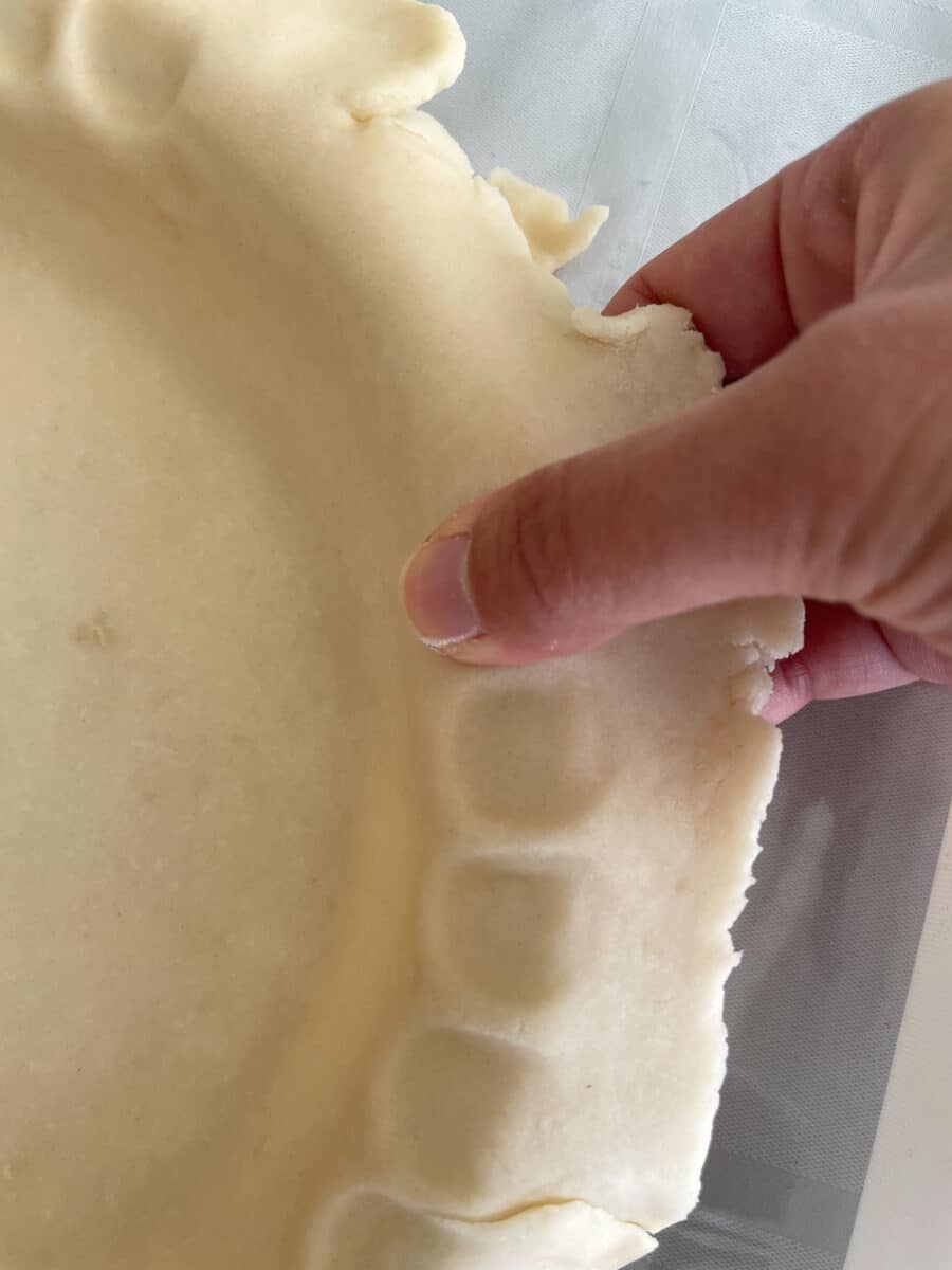 Crimping a pie crust with my thumb.