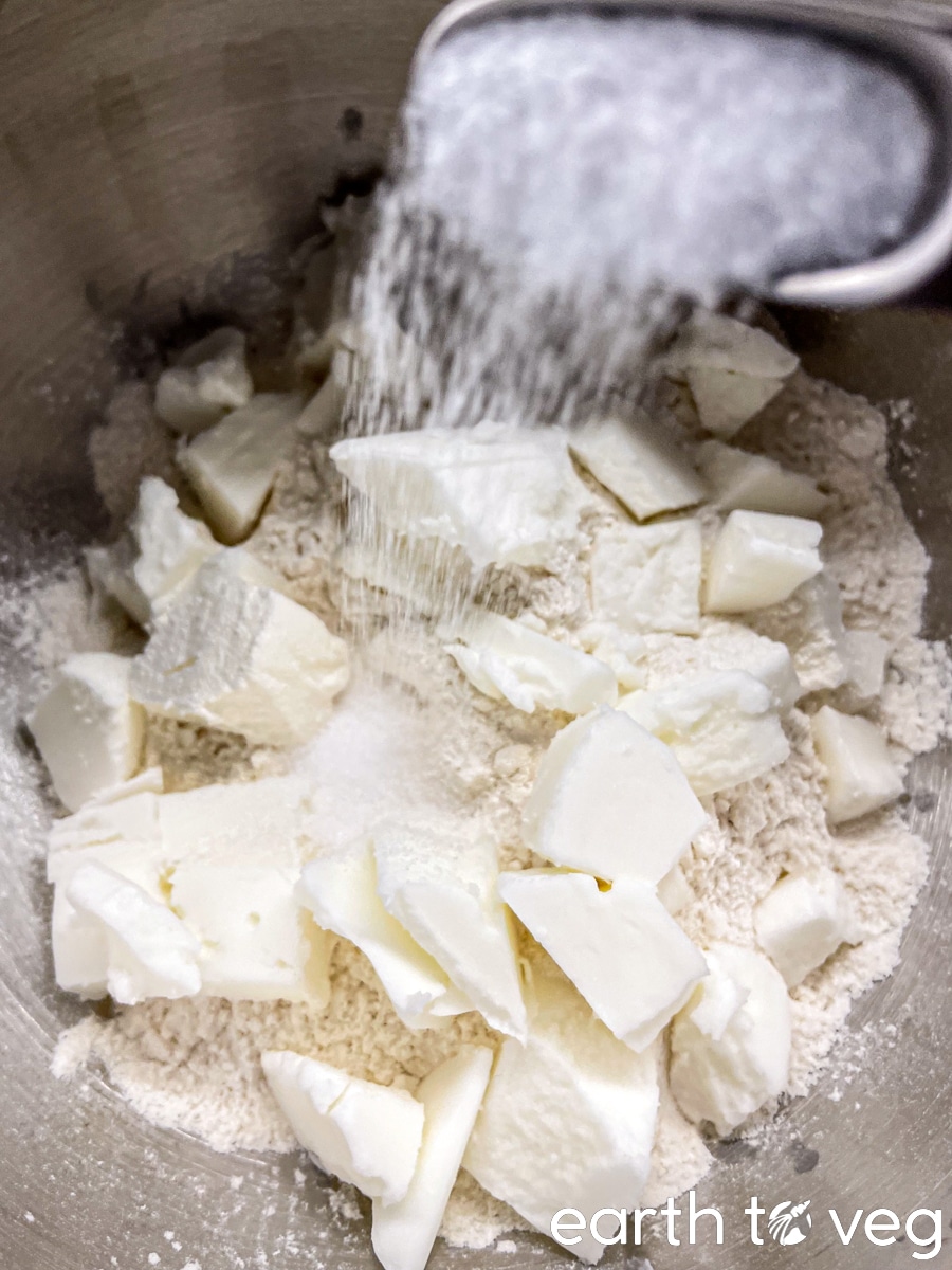 Salt is sprinkled over cubes of cold shortening.