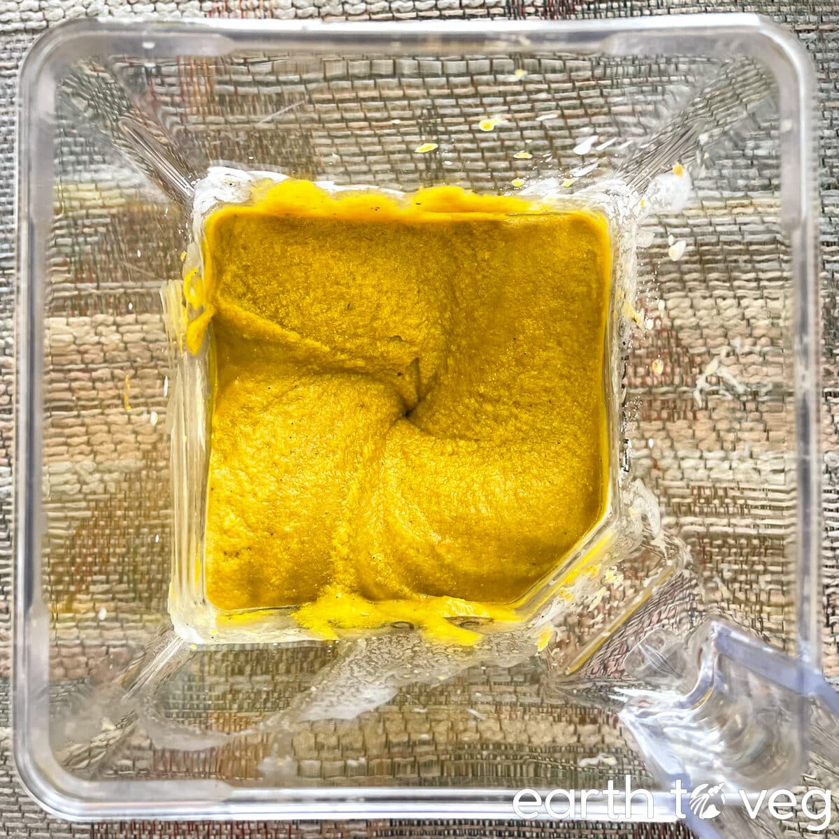 All pumpkin pie filling ingredients are pureed into a smooth mixture inside a Blendtec blender jar.