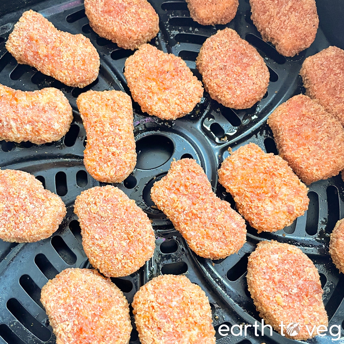 Cooked Alpha Foods Sizzlin' Spicy Chik'n Nuggets on an air fryer tray.