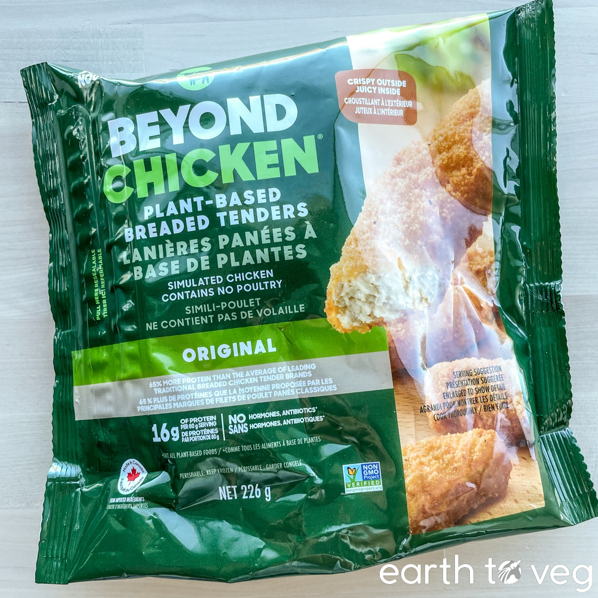A package of frozen Beyond Chicken Plant-Based Breaded Tenders on a wooden table.