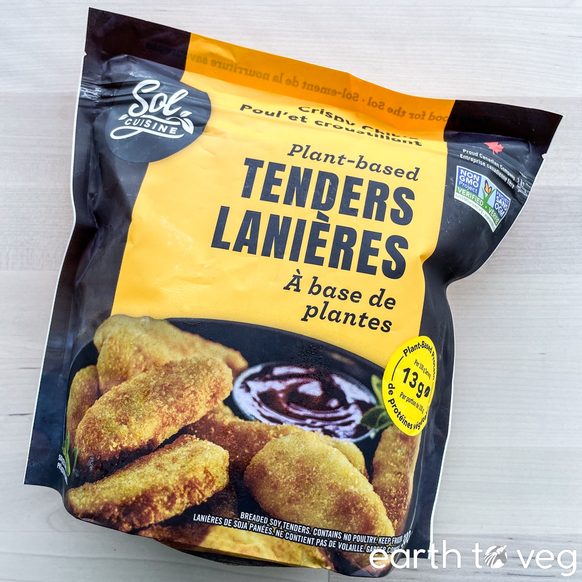 A package of Sol Cuisine Crispy Chick'n Tenders on a wooden table.