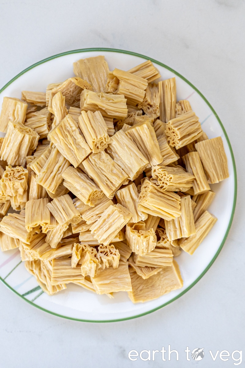 soaked, drained, and chopped bean curd sticks on a plate