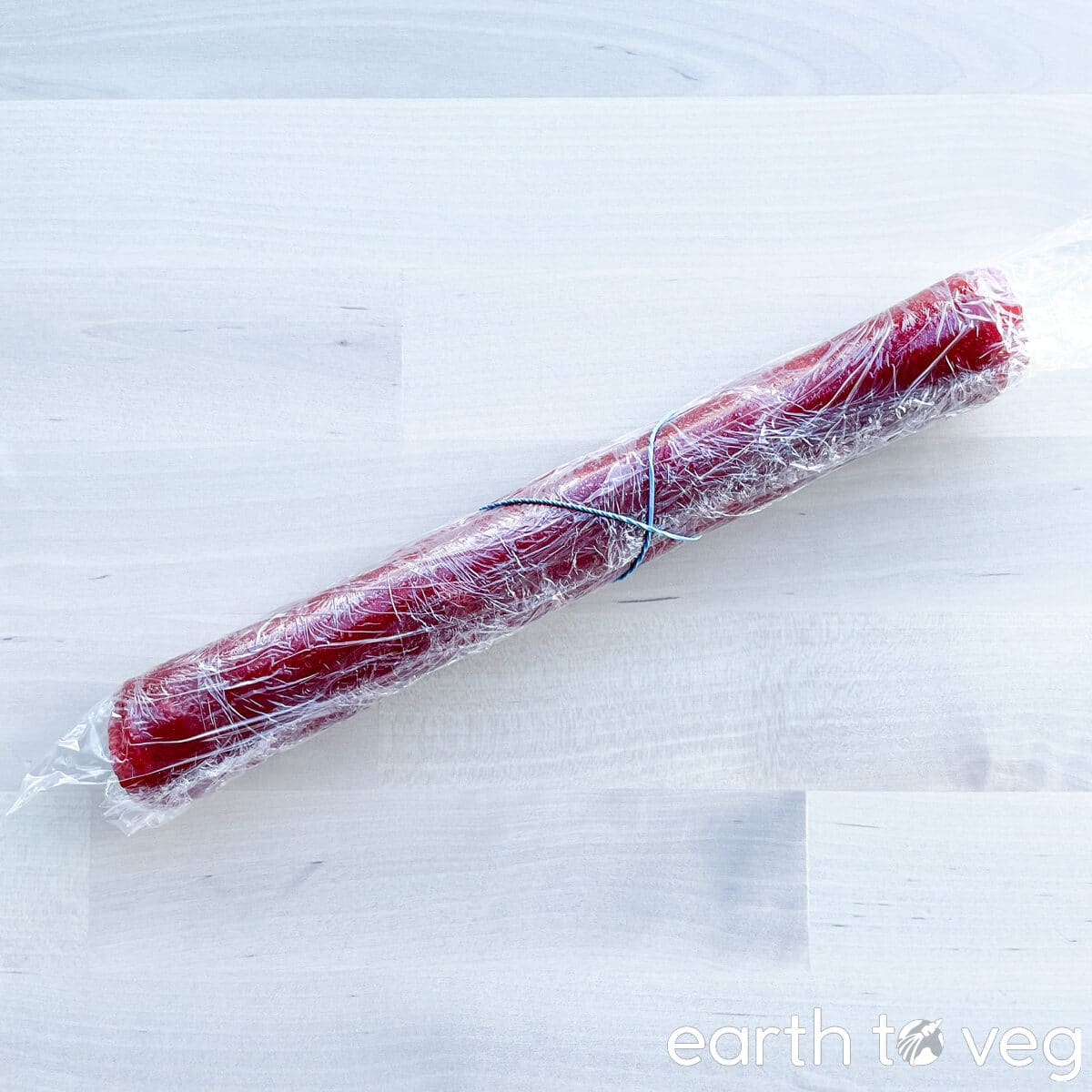 A roll of hawthorn leather wrapped tightly with plastic wrap.