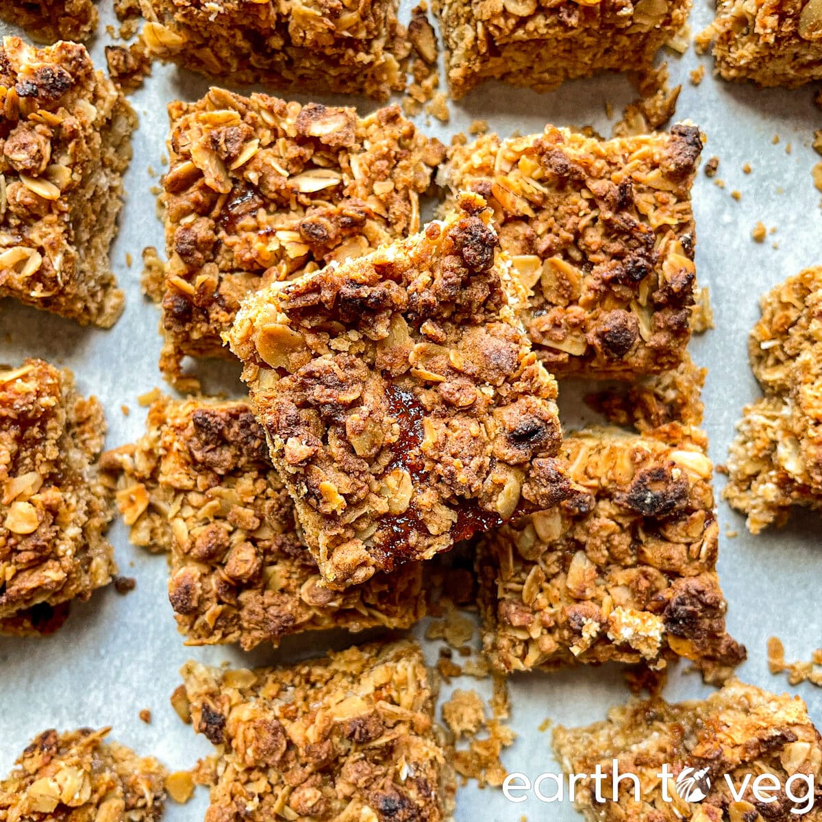 icelandic rhubarb cake squares arranged haphazardly over a grey countertop