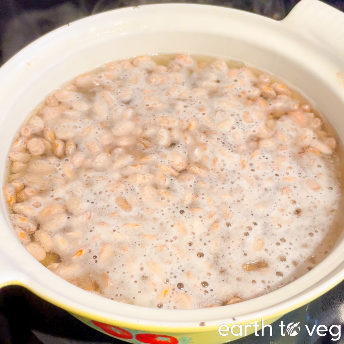 The pot of beans has come to a simmer on the stove.