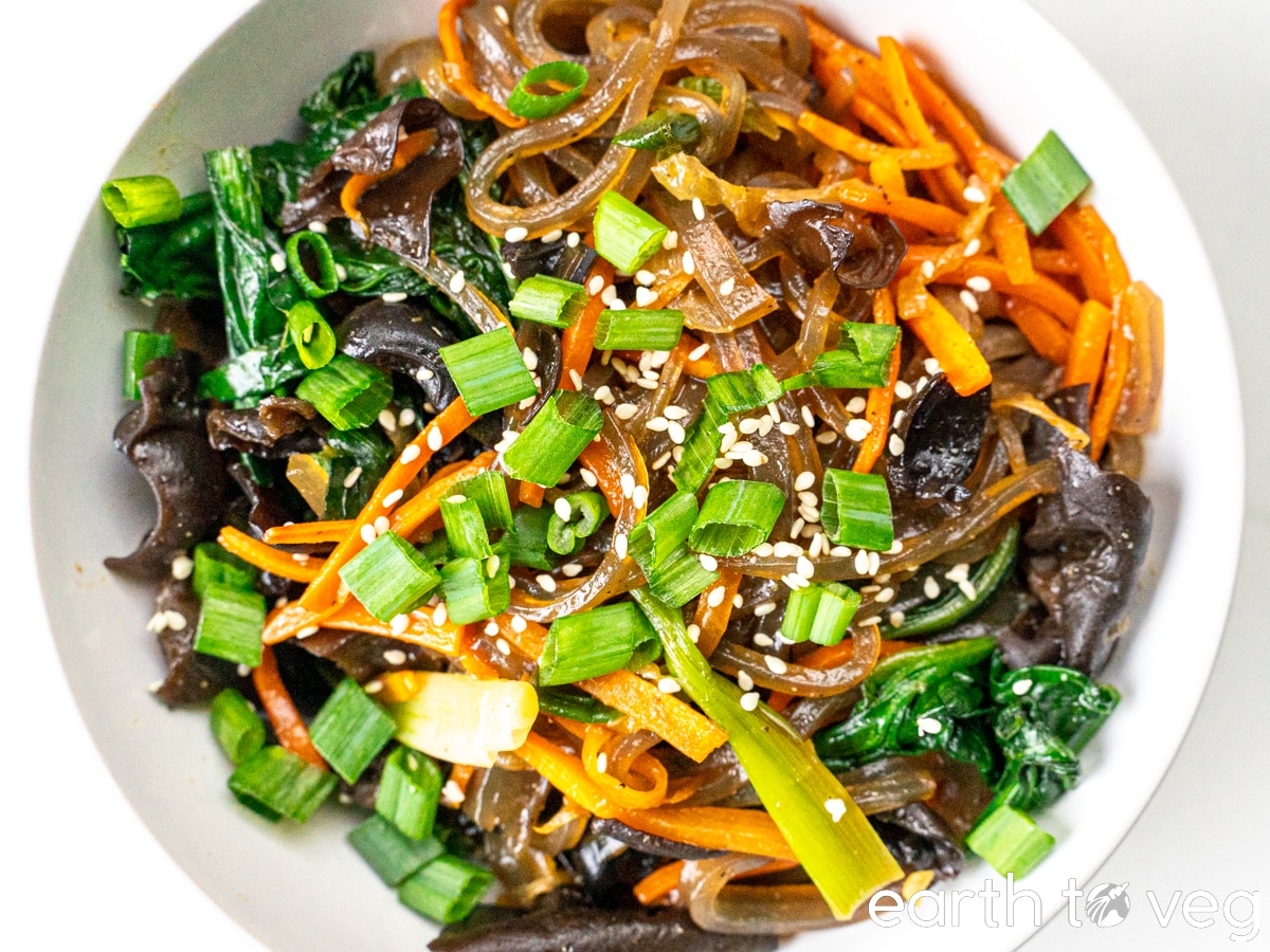 Sesame seeds adorn the top of a bowl of japchae.