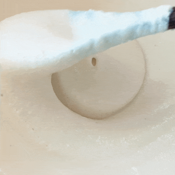 Animation of a spoon stirring thick cashew soy yogurt.