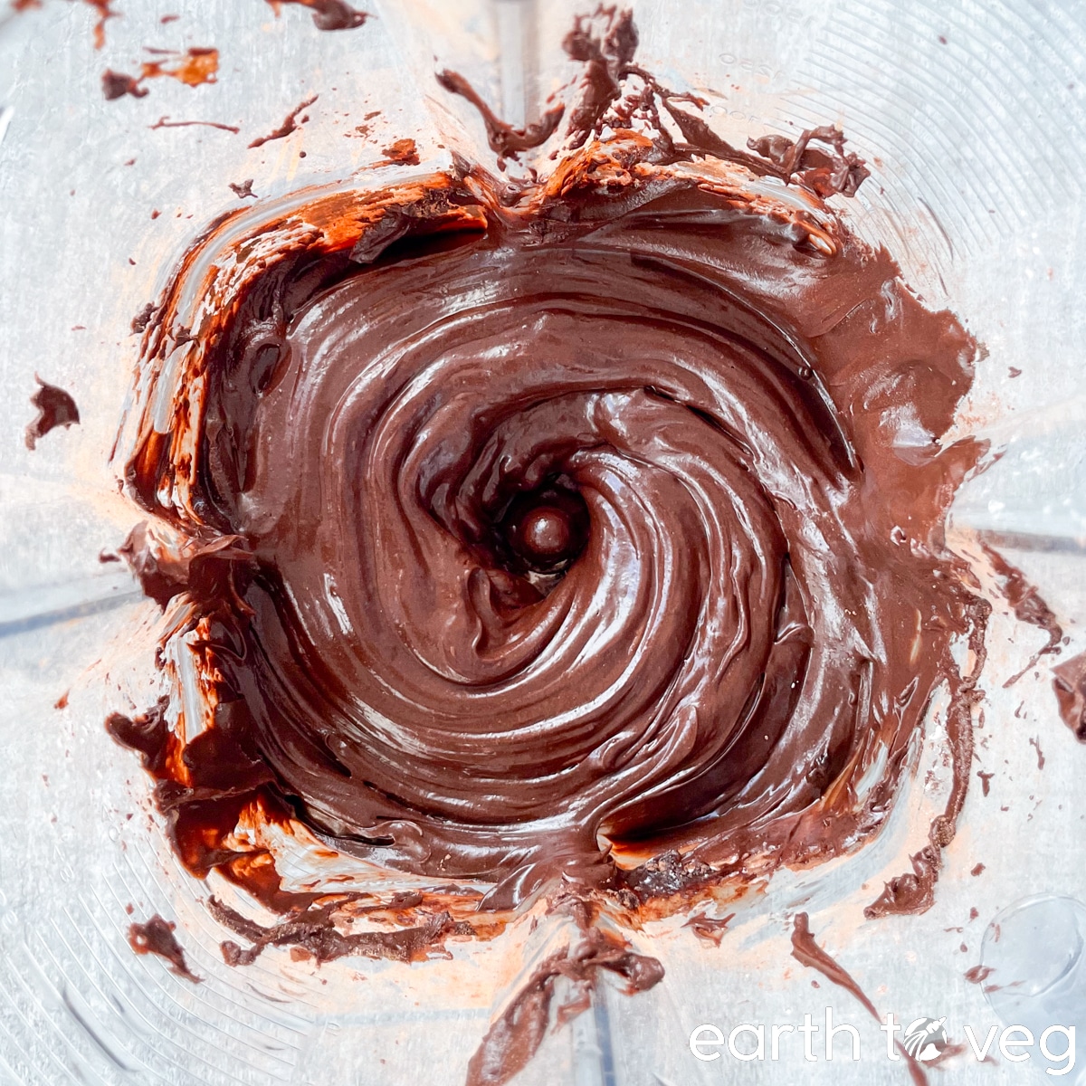 Chocolate frosting in a Vitamix blender jar.