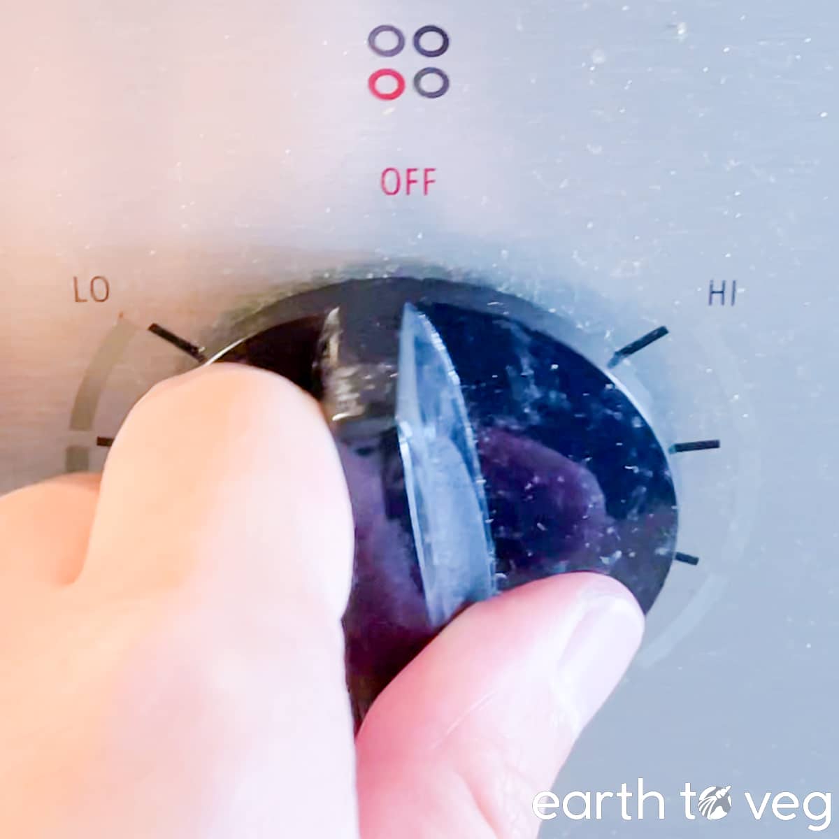 A stove dial is turned to halfway (medium power).