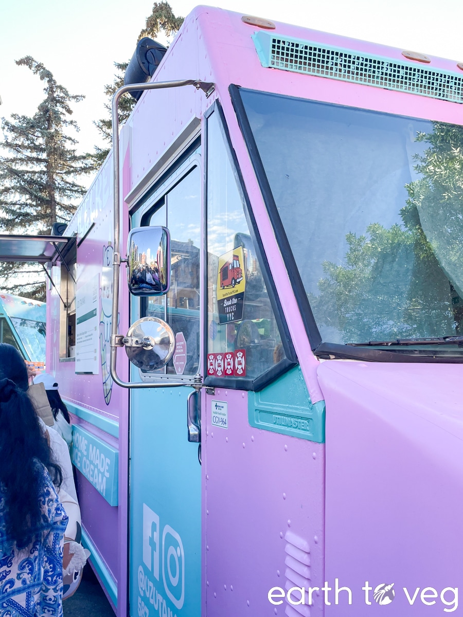 Angled perspective of a purple and teal Uzu Taiyaki food truck.