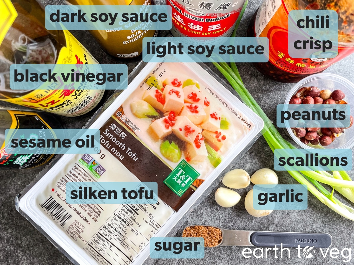 Ingredients for spicy doufunao are laid out on a grey counter.